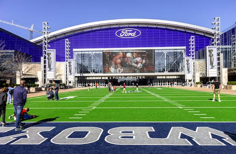A lively scene at the Ford Center sports venue with people enjoying the outdoors.